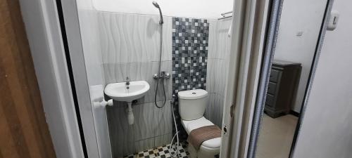 a small bathroom with a sink and a toilet at Smart Tlogomas Syariah in Malang