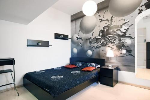 a bedroom with a bed and a wall with balloons at Carol Studio in Bucharest