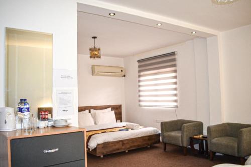 Postel nebo postele na pokoji v ubytování Hikaya studios