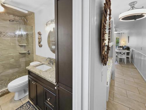 a bathroom with a toilet and a sink and a shower at Inlet Sands - 204 Home in Inlet Beach