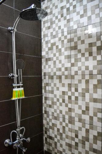 a shower in a bathroom with a tiled wall at Hikaya studios in Wadi Musa