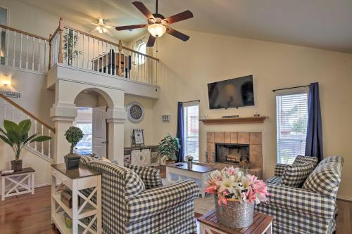 a living room with a ceiling fan and a fireplace at San Antonio Home with Pool and Hot Tub Near SeaWorld! in San Antonio
