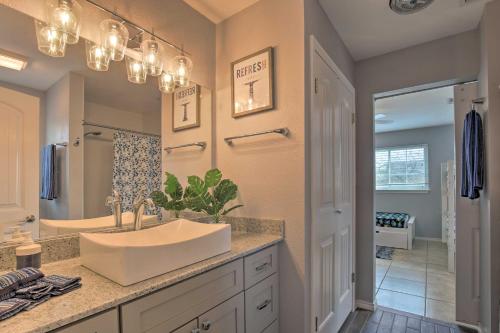 a bathroom with a sink and a large mirror at San Antonio Home with Pool and Hot Tub Near SeaWorld! in San Antonio
