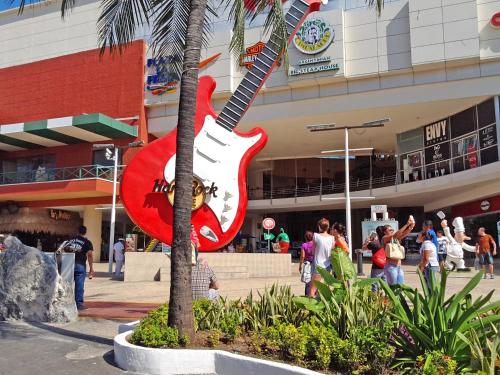 a giant guitar statue in front of a shopping center at Ocean View Condo in Cancún