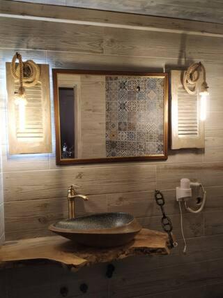 a bathroom with a sink and a mirror at ORFEAS HOUSE 2 in Patitiri