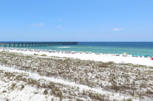 a view of a beach with a pier in the background at Navarre Beach Regency 308 in Navarre