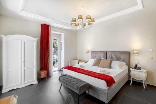 a bedroom with a large bed and a red curtain at Itria Palace in Ragusa