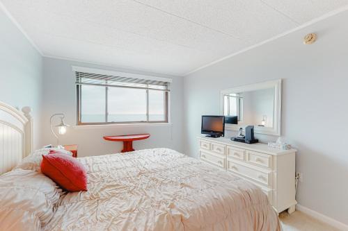 a bedroom with a bed and a dresser and a television at Ocean Towers 3A in Ocean City