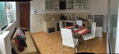 a kitchen and dining room with a table and chairs at Panoramic independent apartment-Regen Wasi in Cusco
