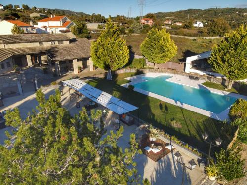 an overhead view of a swimming pool in a yard with trees at Quinta da Amoreira in Covilhã