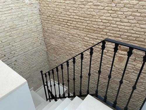 a stair railing next to a brick wall at CASA NAIA Santa Rufina 7 in Seville