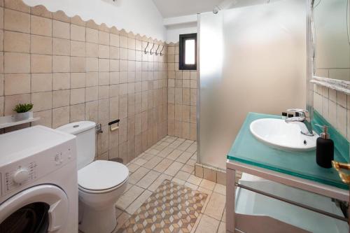 a bathroom with a toilet and a sink at Valentina Home in Málaga