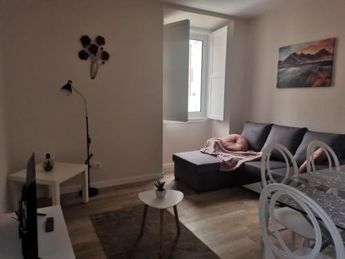 a living room with a couch and a table at Apartamentos São Gião 10 in Tomar
