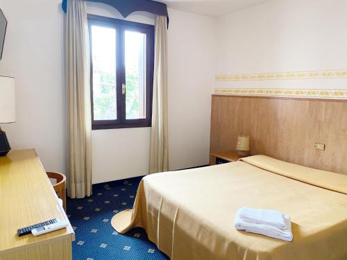 Postel nebo postele na pokoji v ubytování Hotel Al Posta