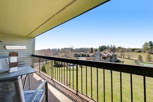 a balcony with a table and chairs and a view at Chetola Cardinal 201 in Blowing Rock
