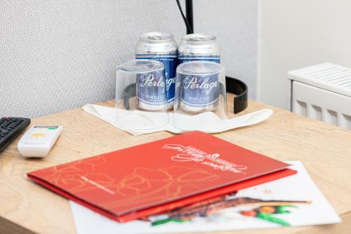 a desk with two cans of beer and a laptop at Hotel nad Wisłą in Tczew