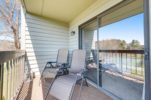 two chairs sitting on the front porch of a house at Chetola Cardinal 201 in Blowing Rock