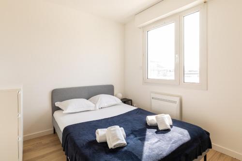 1 dormitorio con 1 cama con 2 toallas en DIFY Bollier - Quartier Gerland, en Lyon