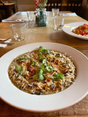 a white bowl of food on a table at The Windmill Inn in Horsham