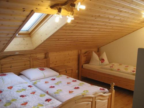 a bedroom with two beds in a attic at Hotel Brückenmühle in Meiningen