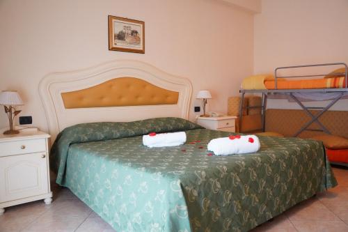 a bedroom with a bed and two bunk beds at Hotel Roscianum Welness SPA in Rossano