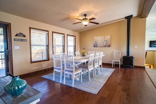 a dining room with a table and white chairs at 24 Quiver Circle Spectacular Mountain View 5 Acres PIKES PEAK in Florissant