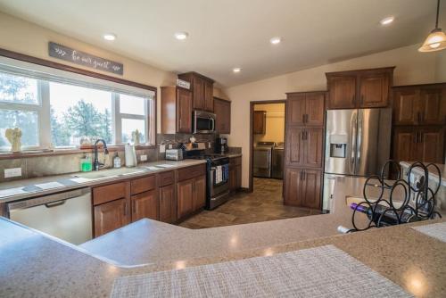 a large kitchen with wooden cabinets and stainless steel appliances at 24 Quiver Circle Spectacular Mountain View 5 Acres PIKES PEAK in Florissant