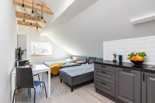 a small kitchen with a bed and a dining room at SuperApart Obywatelska 42 in Warsaw
