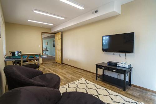 a living room with a couch and a flat screen tv at 24 Quiver Circle Spectacular Mountain View 5 Acres PIKES PEAK in Florissant