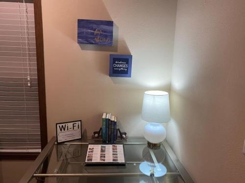 a glass table with a lamp and books on it at 24 Quiver Circle Spectacular Mountain View 5 Acres PIKES PEAK in Florissant