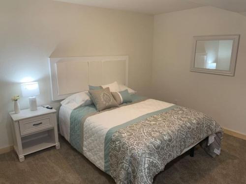 a bedroom with a bed and a table with a night stand at 24 Quiver Circle Spectacular Mountain View 5 Acres PIKES PEAK in Florissant