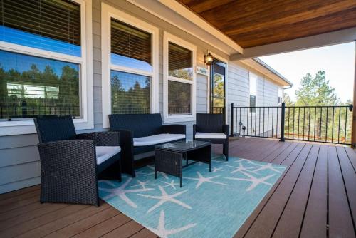 a porch with chairs and a table on a deck at 24 Quiver Circle Spectacular Mountain View 5 Acres PIKES PEAK in Florissant