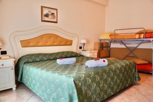 a bedroom with two beds and two bunk beds at Hotel Roscianum Welness SPA in Rossano