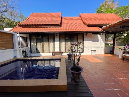 a house with a swimming pool in front of it at Casa Khaoyai Bed&Breakfast in Mu Si