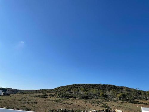 a view of a hill with a blue sky at Magnifique villa El Haouaria-Nabeul in El Haouaria
