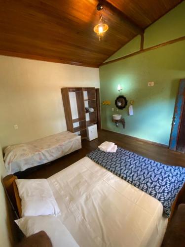 a bedroom with two beds in a room at Pousada Lapralapa in Santana do Riacho
