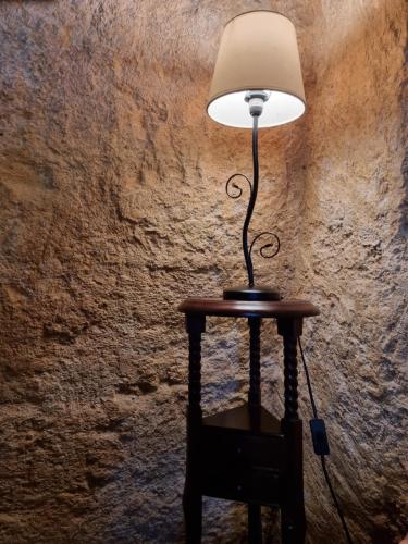 a lamp sitting on a table next to a wall at Torretta ai Sassi in Matera