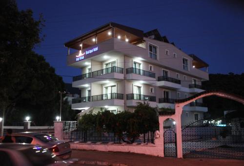 a white building with a sign on it at night at Keyf Konak Boutique Hotel in Aydın