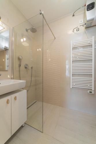 a bathroom with a glass shower and a sink at Perla Luxury Apartment in Split