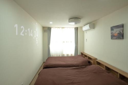 a room with two beds and a window at TKD Asahikawa - Vacation STAY 24510v in Asahikawa