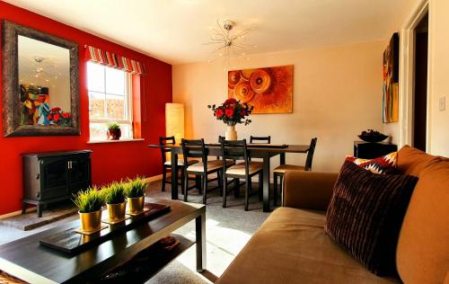 a living room with a couch and a dining room at Have it all.....City, Golf, Beaches & Countryside. in Prestonpans