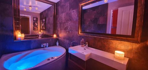 a bathroom with a tub and a sink and a mirror at Have it all.....City, Golf, Beaches & Countryside. in Prestonpans