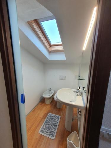 a bathroom with a sink and a skylight at La casa nel vento in Dervio