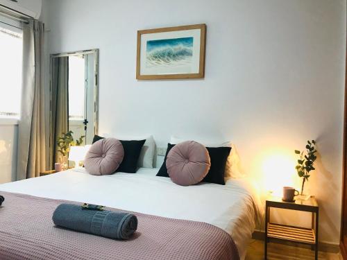 a bedroom with a large white bed with pillows at Apartamento Islote in Famara