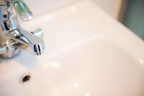 a close up of a bathroom sink with a faucet at Hotelette Seoul Station in Seoul