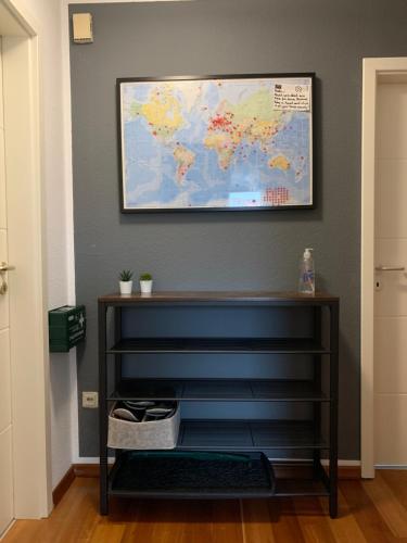 a shelf with a world map on a wall at Apartments Braunschweig - Charlys Home - Küche - Fachwerk - Familie in Braunschweig