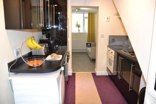 a kitchen with a counter with bananas on it at Olive Tree Apartment - 2 Bedrooms Apartment - Stayseekers in Salisbury
