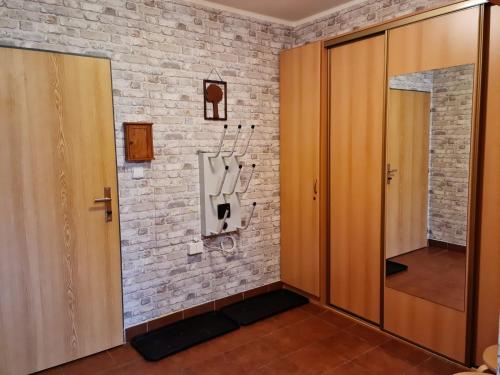 a room with a door and a brick wall at Apartmá Ráj v Ramzové in Ostružná