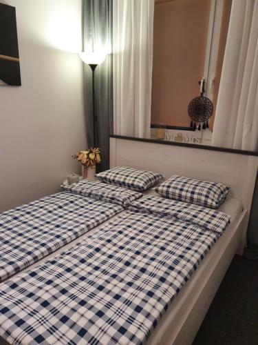 two beds in a room with two pillows on them at Apartament Przy Ratuszu in Malbork