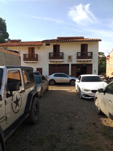 a parking lot with cars parked in front of a building at Casona CHARA in Barichara